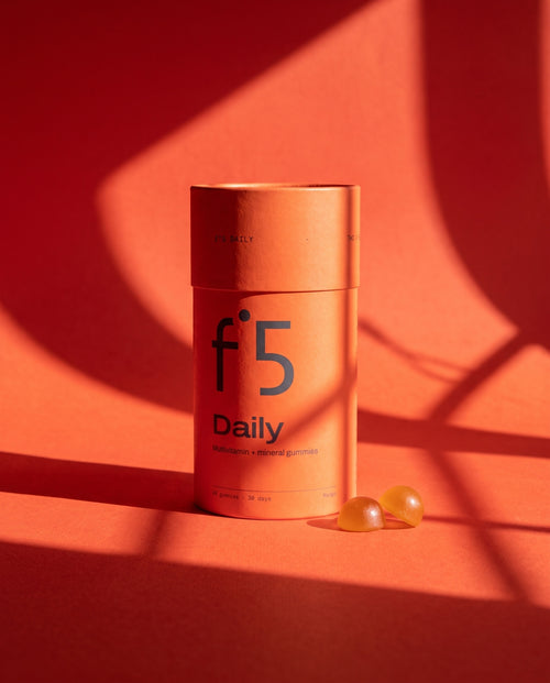 f°5 Daily tube with two mango gummies in morning sun