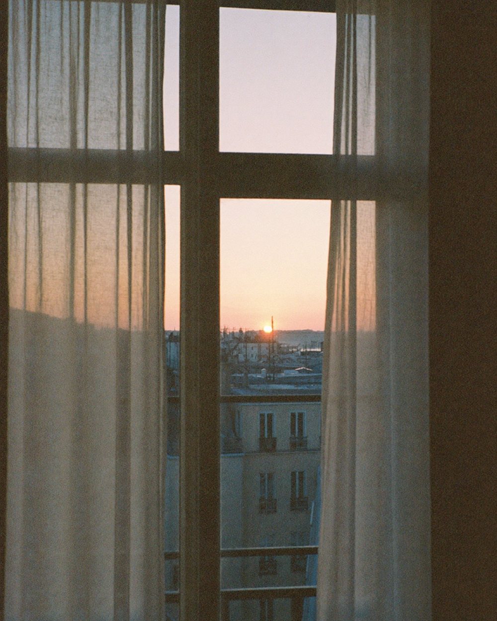 First light over the rooftops through a quiet window